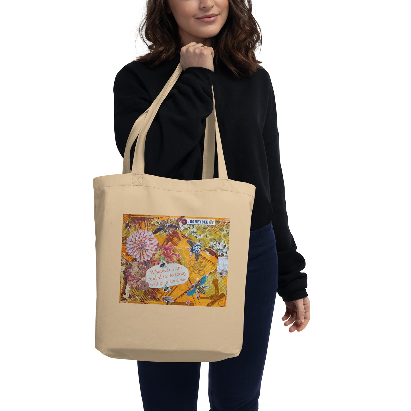image of someone holding the bee eco tote with honey bee art by the double handle straps in a Product mockup