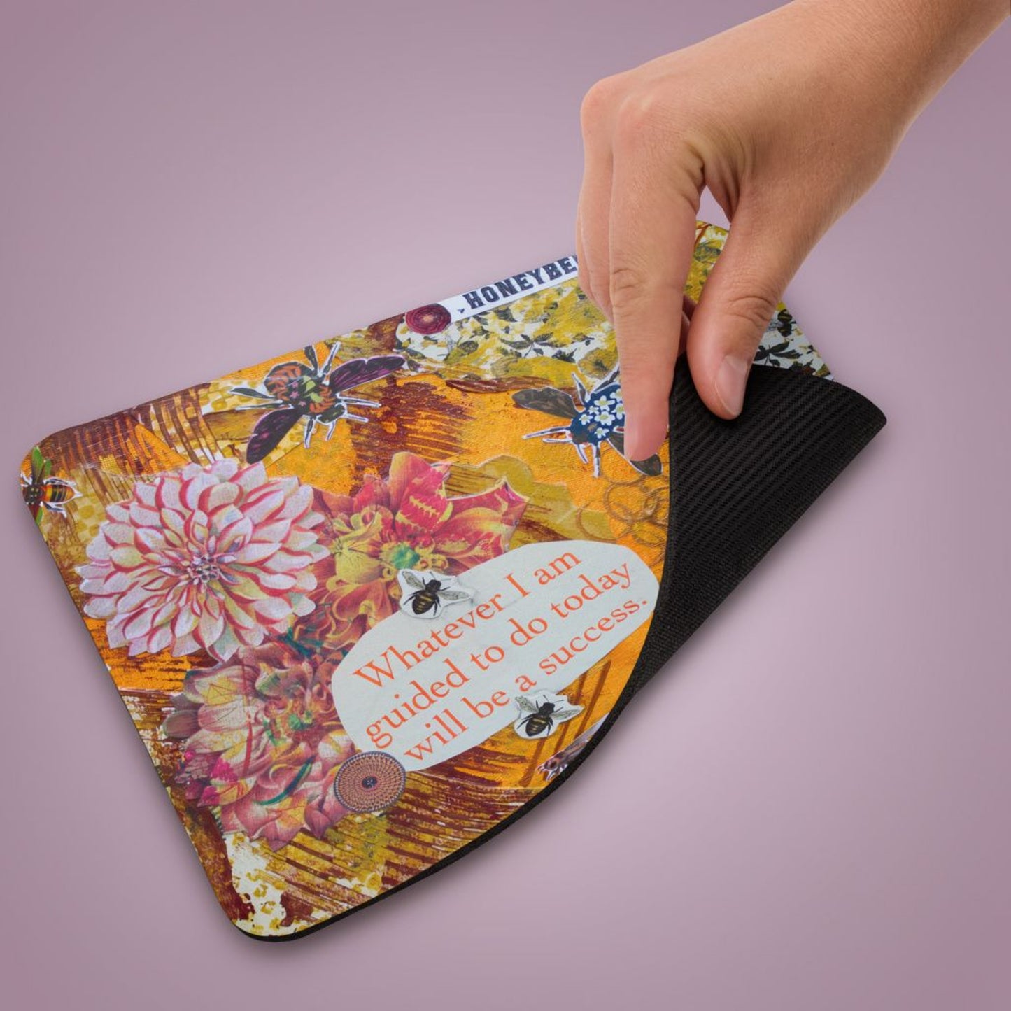honey bee mousepad with honey bee artwork, corner lifted up to show the natural rubber base.