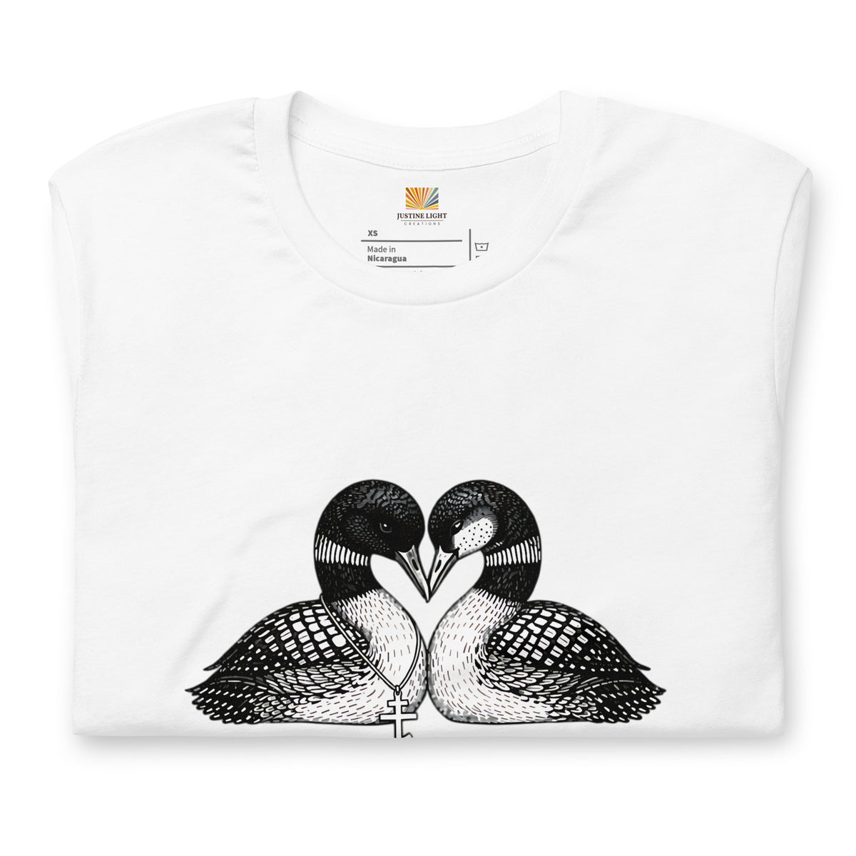 A White folded loon t-shirt featuring a black and white graphic of two loons facing each other, forming a heart with their beaks.
