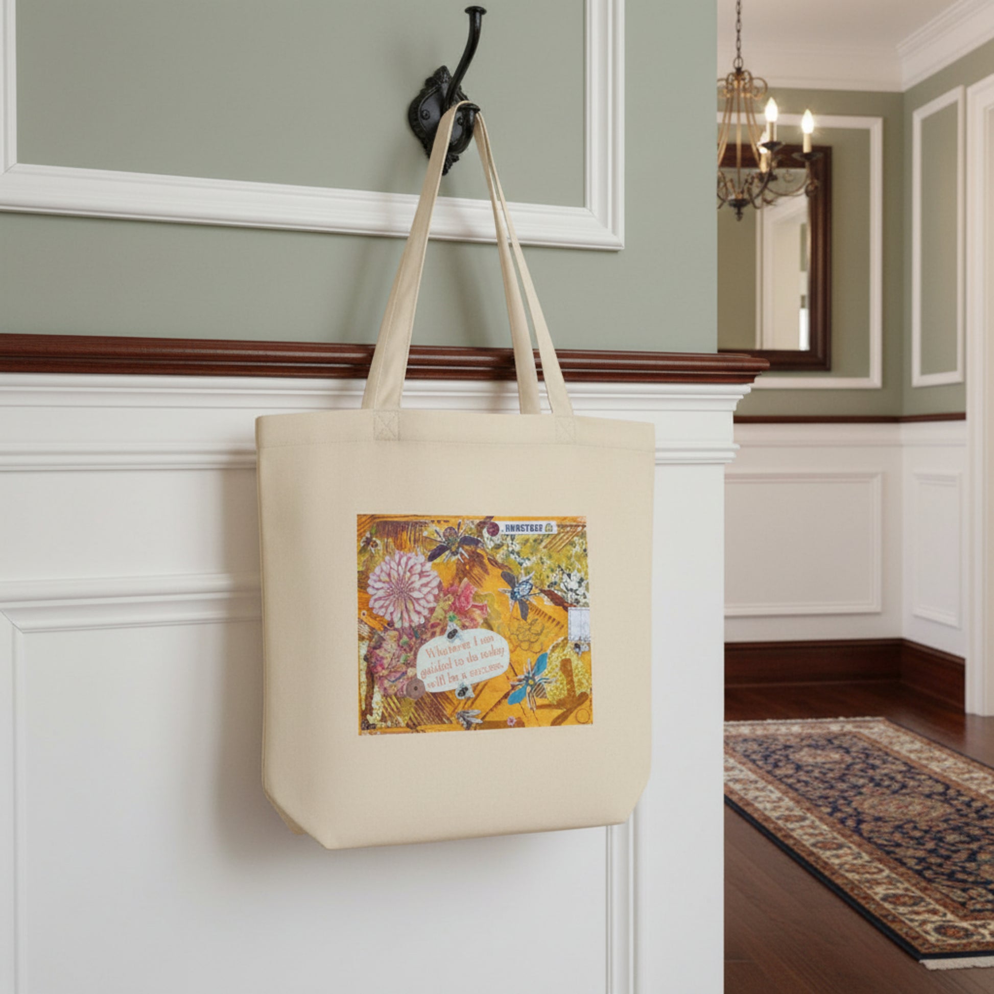 bee eco tote with a bee and colorful design hanging on a white wall.