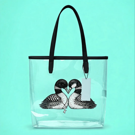 Clear tote bag with black handles featuring a design of two loons forming a heart on a turquoise background.