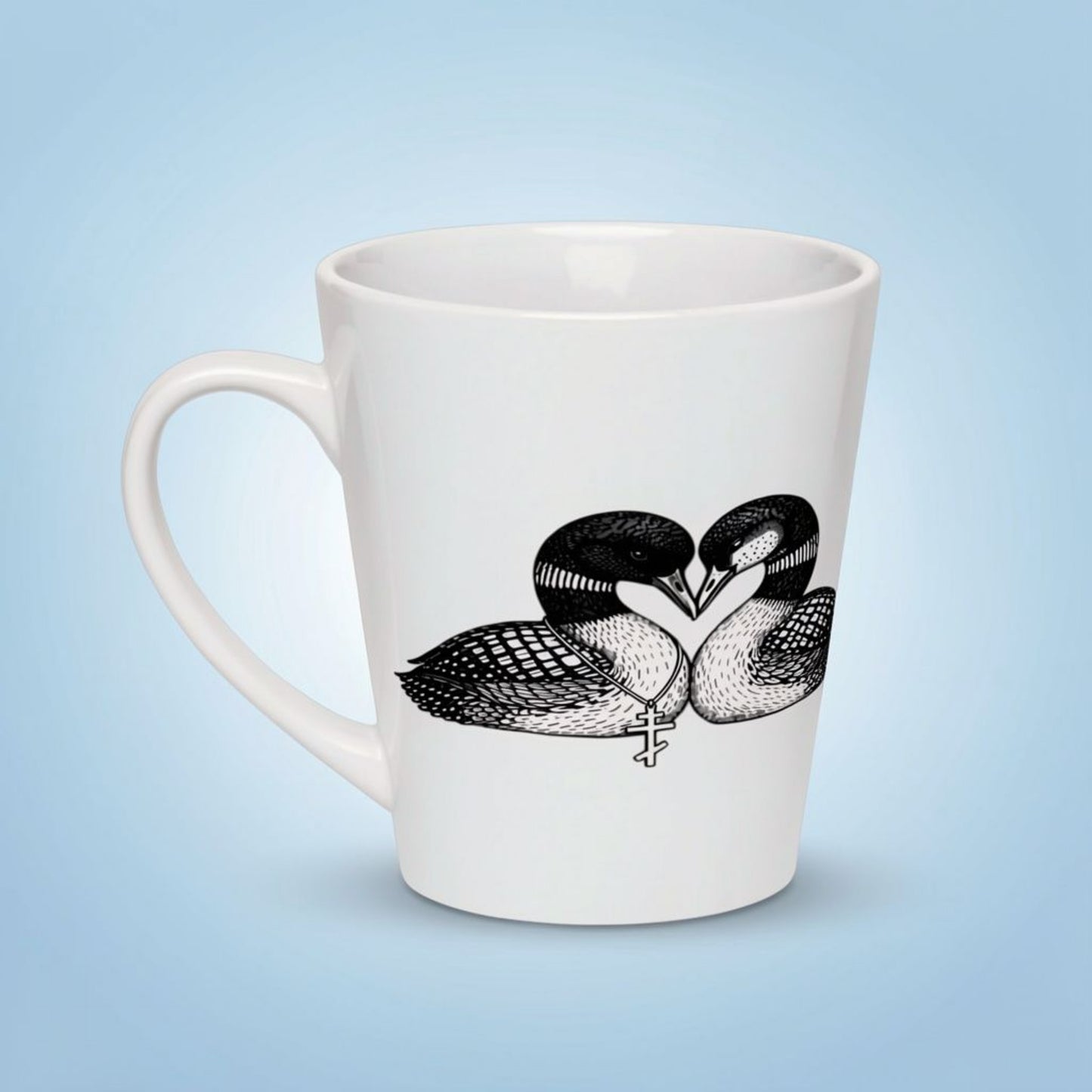 White ceramic latte mug with black and white loons forming a heart shape