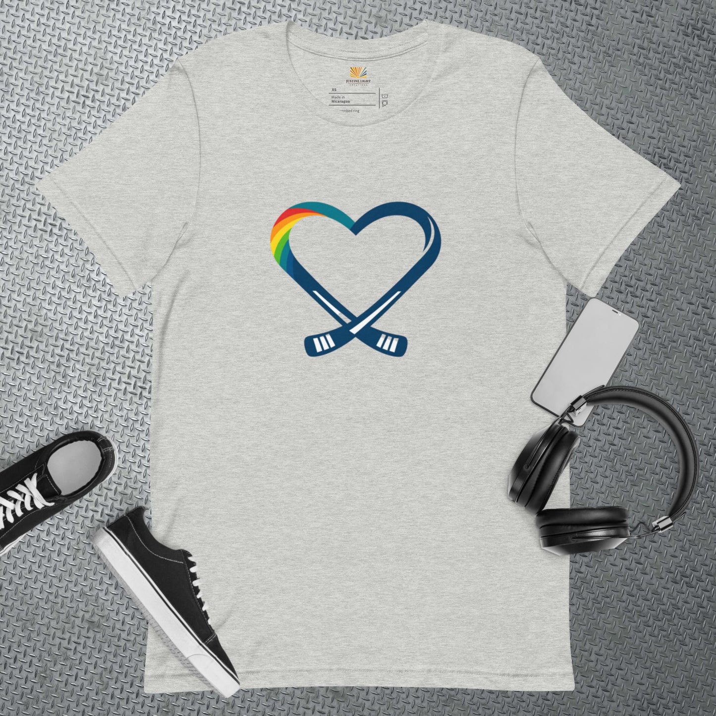 Flat view of rainbow heart t-shirt in athletic heather color with heart hockey logo with rainbow colors on it.