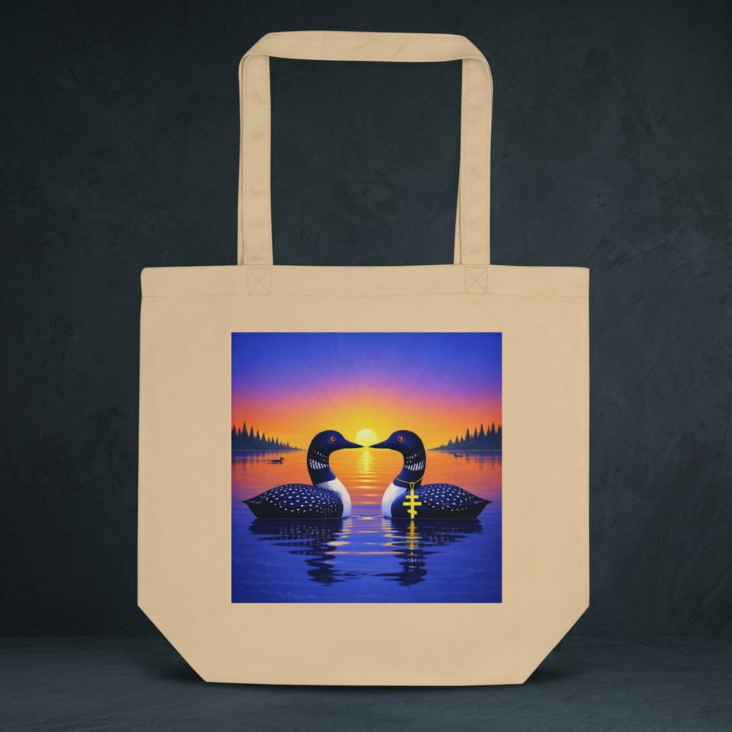 natural colored tote bag with design of two loons on lake at sunrise.