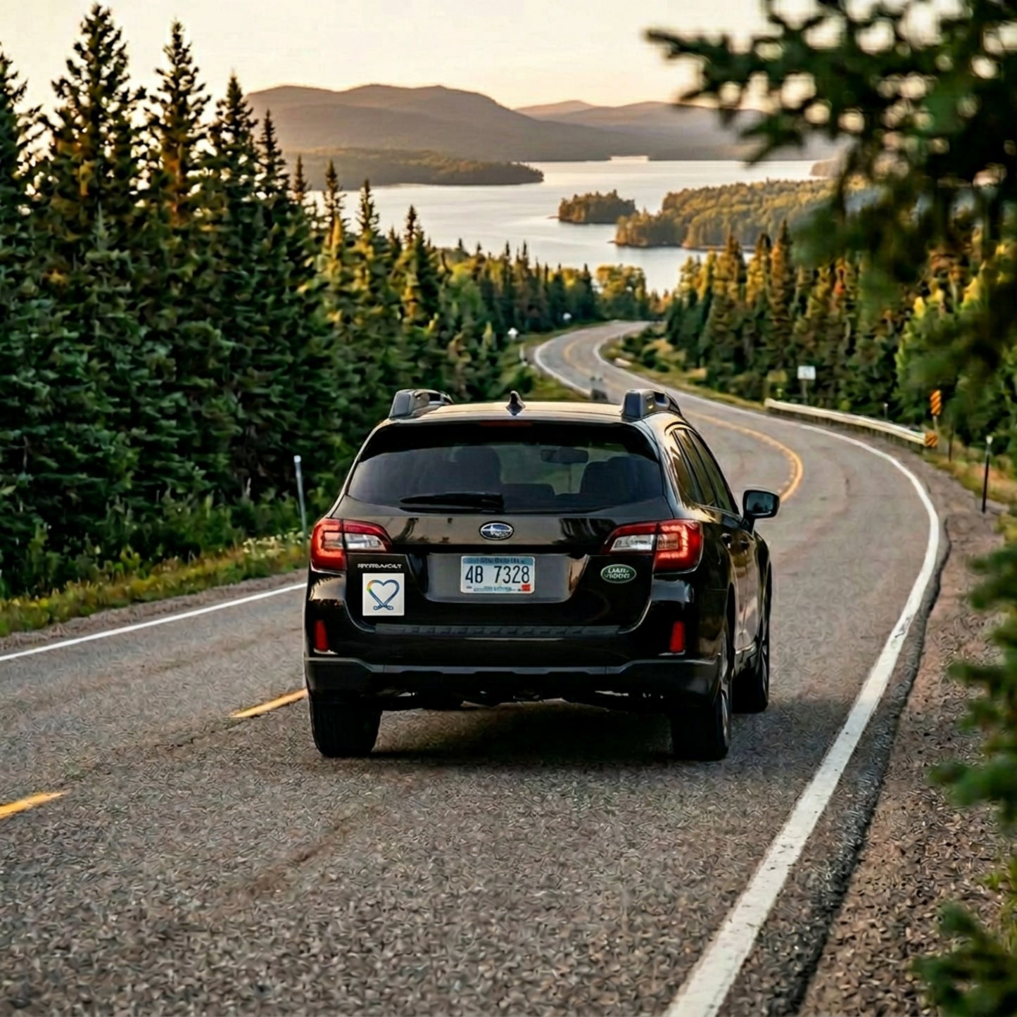 Car driving on road towards a lake with inclusive hockey logo car magnet on the back.