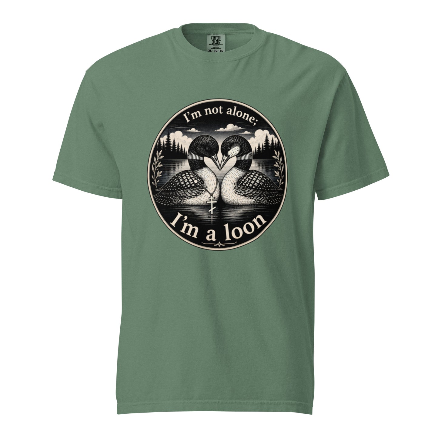 A Light Green colored short-sleeve crewneck t-shirt featuring a circular black and white graphic of two loons facing each other in front of a lake and mountains, with the text 'I'm not alone. I'm a loon'.
