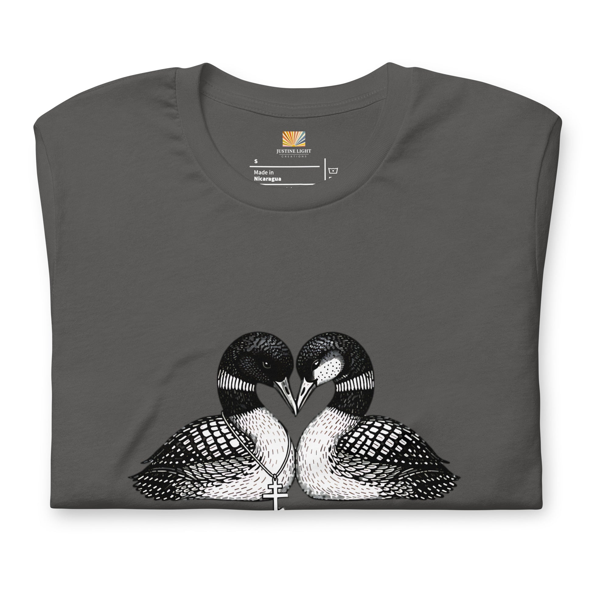 Folded image of hockey romance loon t-shirt with a graphic of two birds, with beaks together forming a heart. Asphalt color shirt