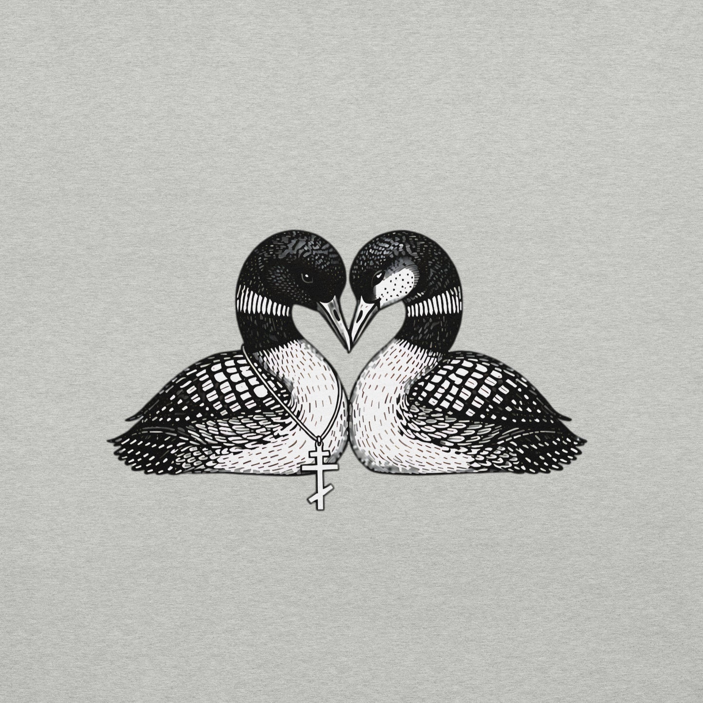 Close view of graphic on a hockey romance loon t-shirt. It has two loons, touching beaks to form a heart shape and one loon has freckles and the other one is wearing a Russian orthodox cross around it's neck- both brids refer to main characters in a popular romance book series and tv show. Shirt color is Athletic Heather