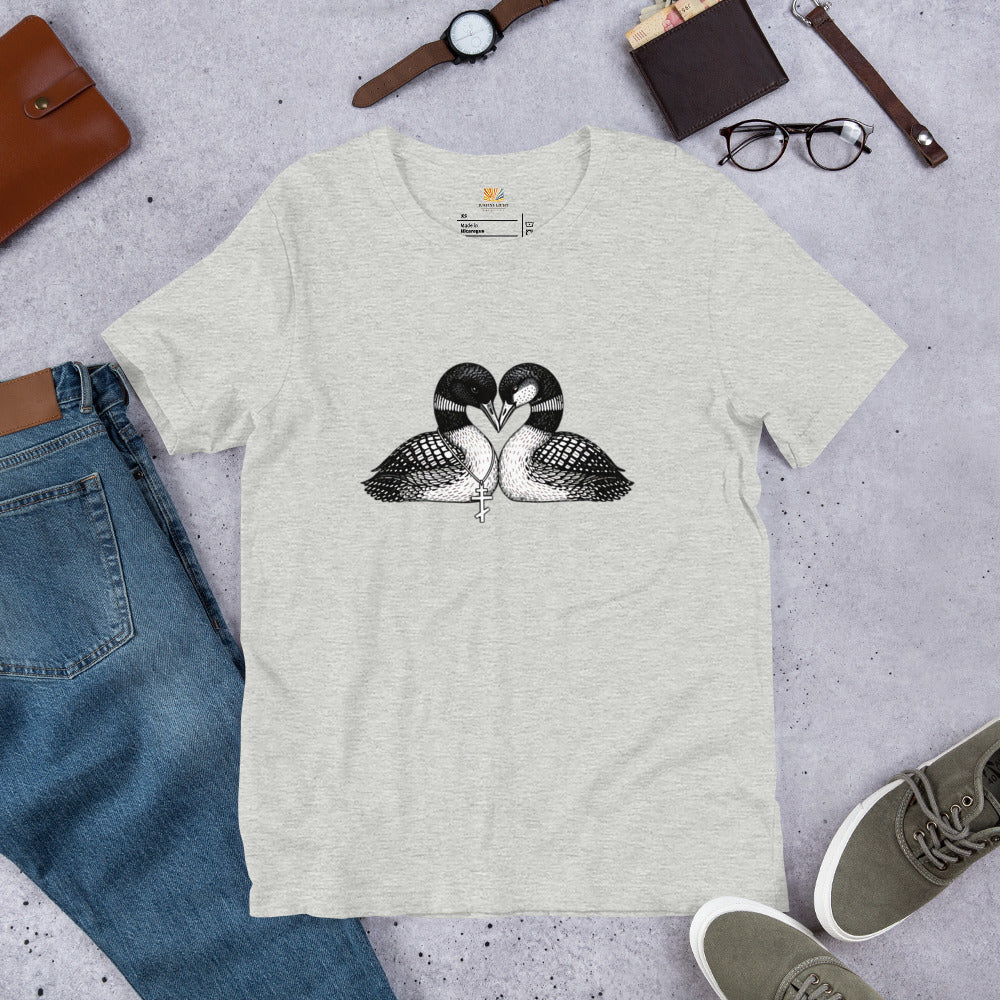 Athletic Heather hockey romance loon t-shirt with a black and white graphic of 2 loons with beaks together forming a heart, one loon wears a Russian orthodox cross around it's neck, the other loon has freckles on it's face.