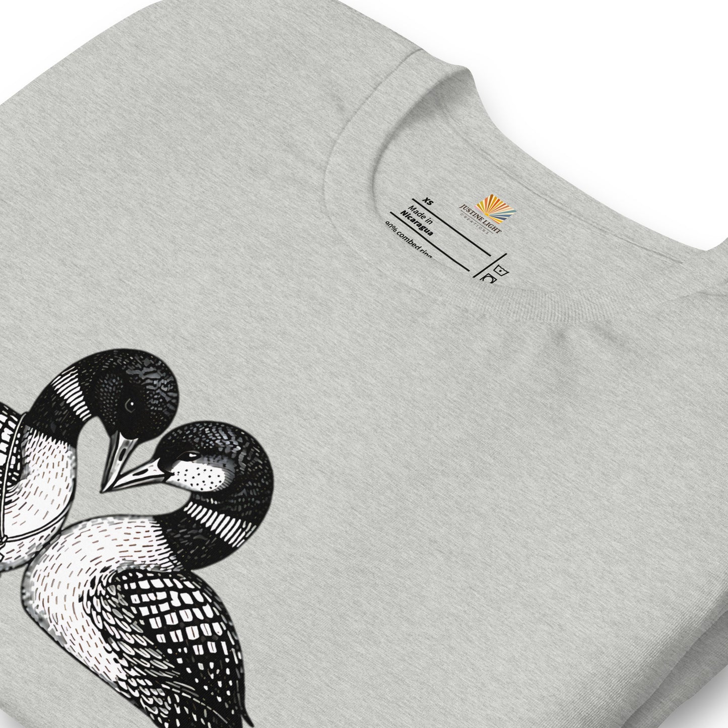 close view of crew style collar on hockey romance loon t-shirt, showing inside label. Athletic Heather colored shirt