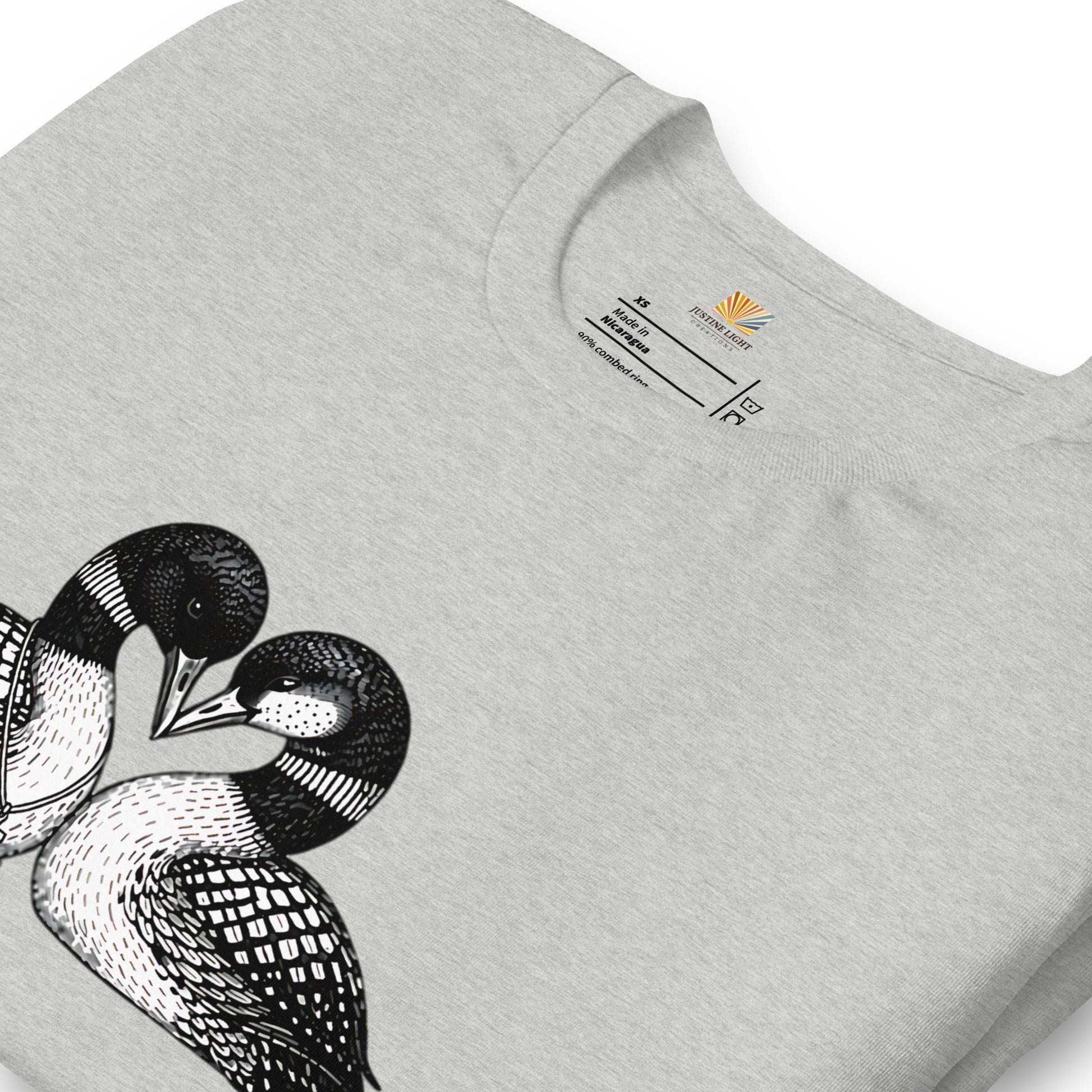 close view of crew style collar on hockey romance loon t-shirt, showing inside label. Athletic Heather colored shirt