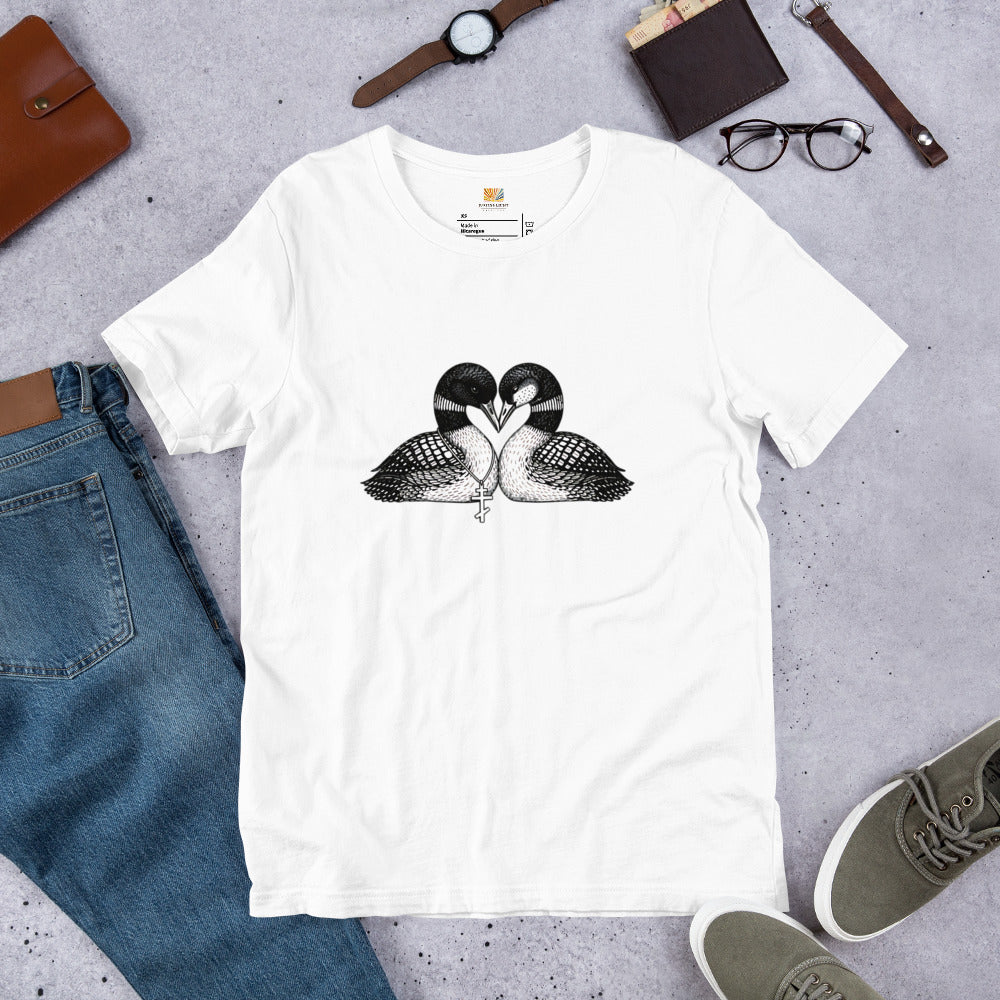 white hockey romance loon t-shirt with a black and white graphic of 2 loons with beaks together forming a heart, one loon wears a Russian orthodox cross around it's neck, the other loon has freckles on it's face.