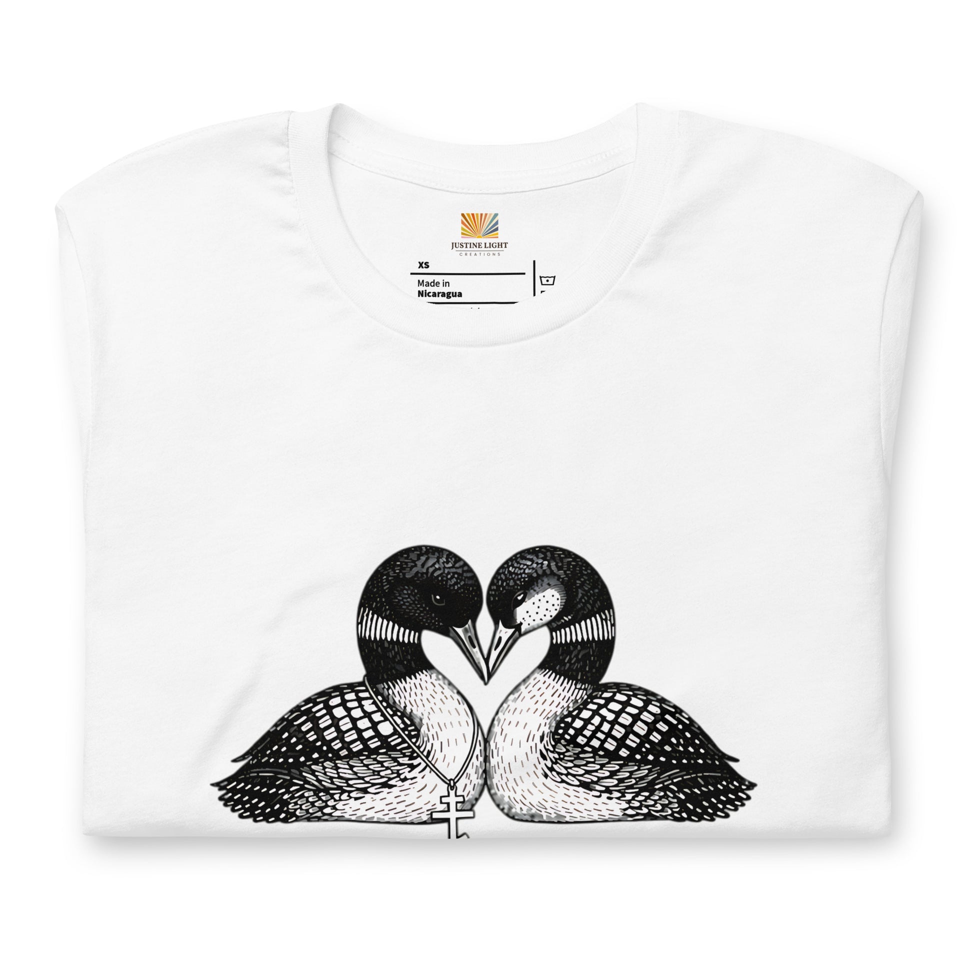 Folded image of hockey romance loon t-shirt with a graphic of two birds, with beaks together forming a heart. White color shirt